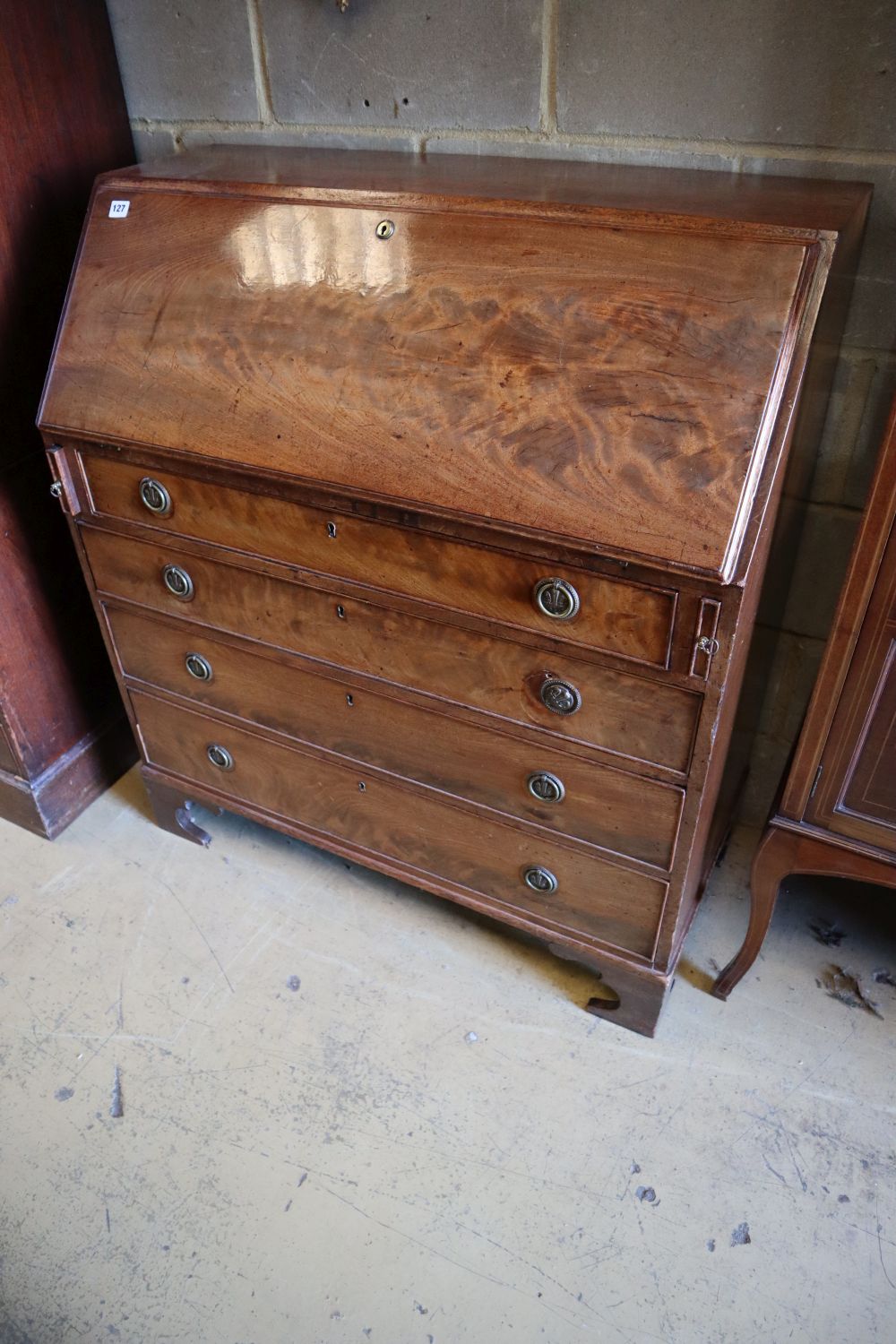 A George III mahogany bureau, fitted four long drawers, width 99cm